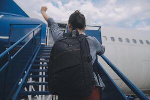 Happy attractive asian woman traveler with backpack at the modern airport terminal, copy space, Tourist journey trip concept photo