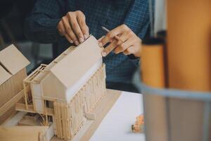 Construction and structure concept of Engineer or architect meeting for project working with partner and engineering tools on model building and blueprint in working site, contract for both companies. photo