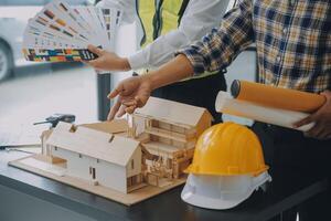 Construction and structure concept of Engineer or architect meeting for project working with partner and engineering tools on model building and blueprint in working site, contract for both companies. photo