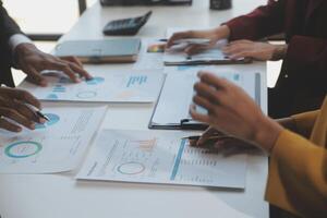 Financial analysts analyze business financial reports on a digital tablet planning investment project during a discussion at a meeting of corporate showing the results of their successful teamwork. photo