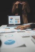 Financial analysts analyze business financial reports on a digital tablet planning investment project during a discussion at a meeting of corporate showing the results of their successful teamwork. photo