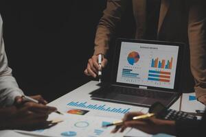 Financial analysts analyze business financial reports on a digital tablet planning investment project during a discussion at a meeting of corporate showing the results of their successful teamwork. photo