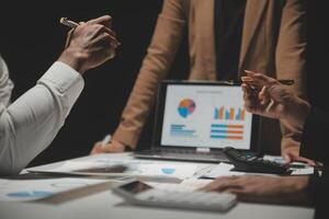 Financial analysts analyze business financial reports on a digital tablet planning investment project during a discussion at a meeting of corporate showing the results of their successful teamwork. photo