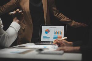 Financial analysts analyze business financial reports on a digital tablet planning investment project during a discussion at a meeting of corporate showing the results of their successful teamwork. photo