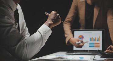 Financial analysts analyze business financial reports on a digital tablet planning investment project during a discussion at a meeting of corporate showing the results of their successful teamwork. photo