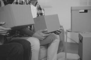 Two Asian blogger showing clothes in front of the camera to recording vlog video live streaming at her shop. Online Shopping Cart notion. on sofa at home photo