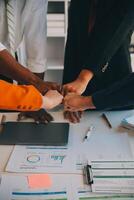Large business team showing unity with their hands together photo