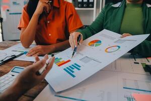 Co working conference, Business team meeting present, investor colleagues discussing new plan financial graph data on office table with laptop and digital tablet, Finance, accounting, investment. photo