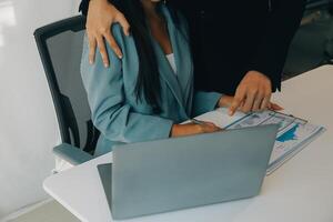 Sexsual harassment in workplace. Unhappy female employee looking at hand of boss touch at her shoulder and feeling disgusted. photo