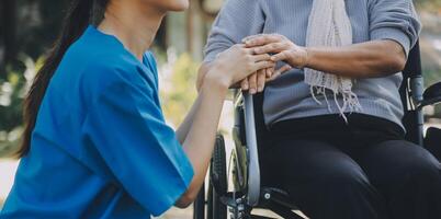 Young asian caretaker with 60s asia elderly woman consulting and encourage, take a history and recommend the right treatment to live happily in retirement, holding hands and encouraging photo