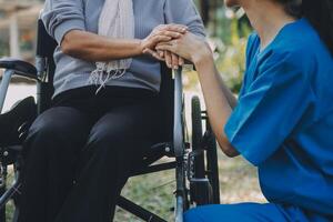 Young asian caretaker with 60s asia elderly woman consulting and encourage, take a history and recommend the right treatment to live happily in retirement, holding hands and encouraging photo