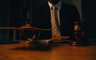 Judge gavel with Justice lawyers having team meeting at law firm background. Concepts of Law and Legal services. photo
