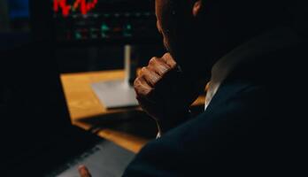 Thoughtful focused successful caucasian male stock investor, broker, financial adviser, sits at work desk, looks at computer, pensively analyze risks and prospects, rise or fall of cryptocurrency coin photo