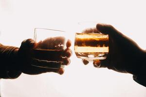 Whiskey splashing out of glass, isolated on white background photo