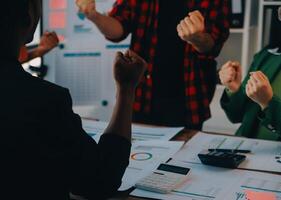 Cheerful business colleagues applauding in meeting at coworking office photo