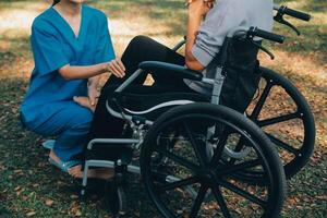 young asian physical therapist working with senior woman on walking with a walker photo