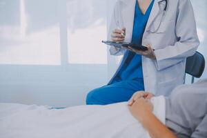 Female doctor administers specialized medical treatment to a patient in a hospital room. The procedure includes fluid therapy and injections to support the patient's health diagnosis and recovery. photo