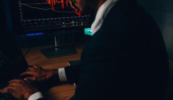 Thoughtful focused successful caucasian male stock investor, broker, financial adviser, sits at work desk, looks at computer, pensively analyze risks and prospects, rise or fall of cryptocurrency coin photo