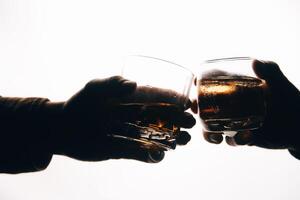 Whiskey splashing out of glass, isolated on white background photo