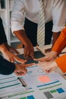 Large business team showing unity with their hands together photo