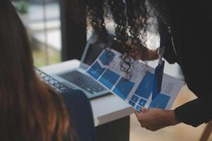 Close up ux developer and ui designer use augmented reality brainstorming about mobile app interface wireframe design on desk at modern office.Creative digital development agency photo