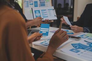 Close up ux developer and ui designer use augmented reality brainstorming about mobile app interface wireframe design on desk at modern office.Creative digital development agency photo