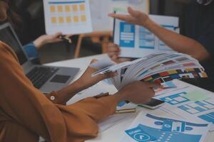 Close up ux developer and ui designer use augmented reality brainstorming about mobile app interface wireframe design on desk at modern office.Creative digital development agency photo