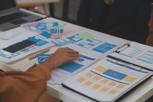 Close up ux developer and ui designer use augmented reality brainstorming about mobile app interface wireframe design on desk at modern office.Creative digital development agency photo