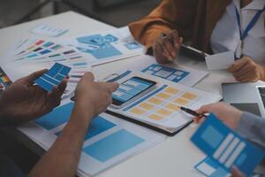 Close up ux developer and ui designer use augmented reality brainstorming about mobile app interface wireframe design on desk at modern office.Creative digital development agency photo