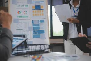 Close up ux developer and ui designer use augmented reality brainstorming about mobile app interface wireframe design on desk at modern office.Creative digital development agency photo
