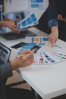 Close up ux developer and ui designer use augmented reality brainstorming about mobile app interface wireframe design on desk at modern office.Creative digital development agency photo