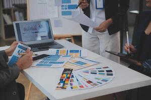 Close up ux developer and ui designer use augmented reality brainstorming about mobile app interface wireframe design on desk at modern office.Creative digital development agency photo