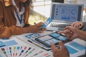 Close up ux developer and ui designer use augmented reality brainstorming about mobile app interface wireframe design on desk at modern office.Creative digital development agency photo