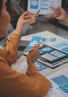 Close up ux developer and ui designer use augmented reality brainstorming about mobile app interface wireframe design on desk at modern office.Creative digital development agency photo