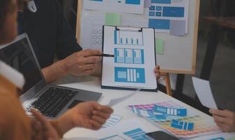 Close up ux developer and ui designer use augmented reality brainstorming about mobile app interface wireframe design on desk at modern office.Creative digital development agency photo