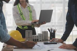 Construction and structure concept of Engineer or architect meeting for project working with partner and engineering tools on model building and blueprint in working site, contract for both companies. photo