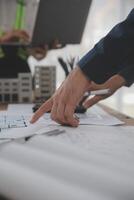 Construction and structure concept of Engineer or architect meeting for project working with partner and engineering tools on model building and blueprint in working site, contract for both companies. photo