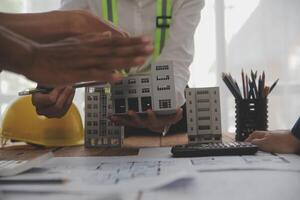 Construction and structure concept of Engineer or architect meeting for project working with partner and engineering tools on model building and blueprint in working site, contract for both companies. photo
