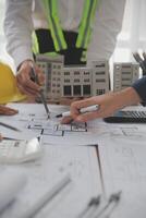 Construction and structure concept of Engineer or architect meeting for project working with partner and engineering tools on model building and blueprint in working site, contract for both companies. photo