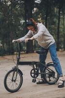 Happy Asian young woman walk and ride bicycle in park, street city her smiling using bike of transportation, ECO friendly, People lifestyle concept. photo