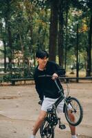 Handsome happy young man with bicycle on a city street, Active lifestyle, people concept photo