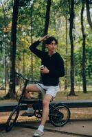 Handsome happy young man with bicycle on a city street, Active lifestyle, people concept photo