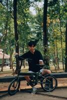 Handsome happy young man with bicycle on a city street, Active lifestyle, people concept photo