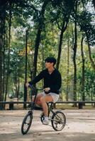 Handsome happy young man with bicycle on a city street, Active lifestyle, people concept photo