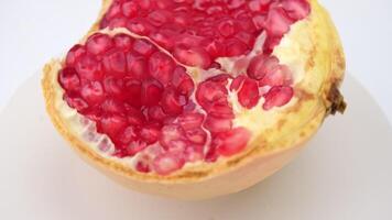 Juicy red pomegranate cut in half close up. Fresh ripe pomegranate. Ripe fruit is a healthy food. video