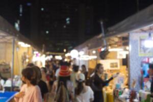 blur defocus people walking on the street at night market photo