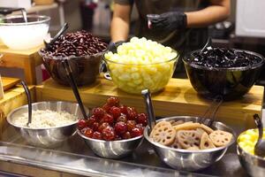 Thai Chinese Shaved ice dessert  with combination of ingredients . Sugar palm seed , Toddy Palm ,  Sweet Baby Palm , Red Bean , Ginkgo Nut , Black Jelly , Lotus Root , Coconut photo