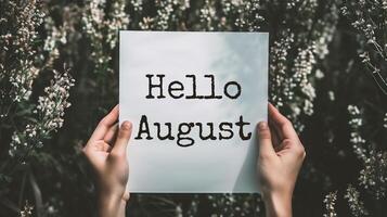 AI generated Female hands holding Hello August card with flowers background. Vintage tone. photo