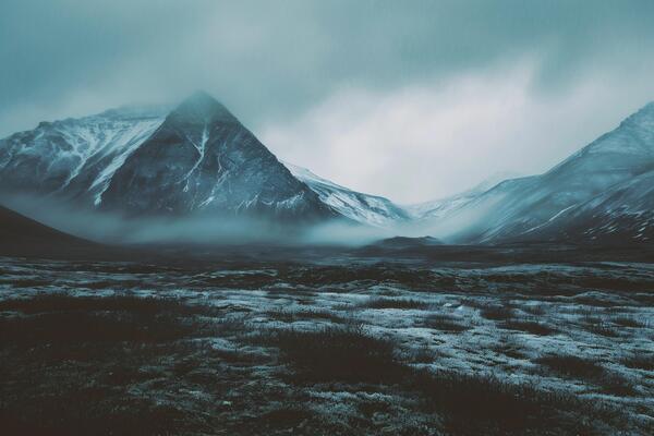 AI generated Icelandic mountain landscape with snow and fog.