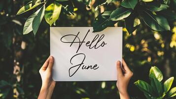 AI generated Hello June. Closeup of a woman holding a card with the word Hello June in her hands photo